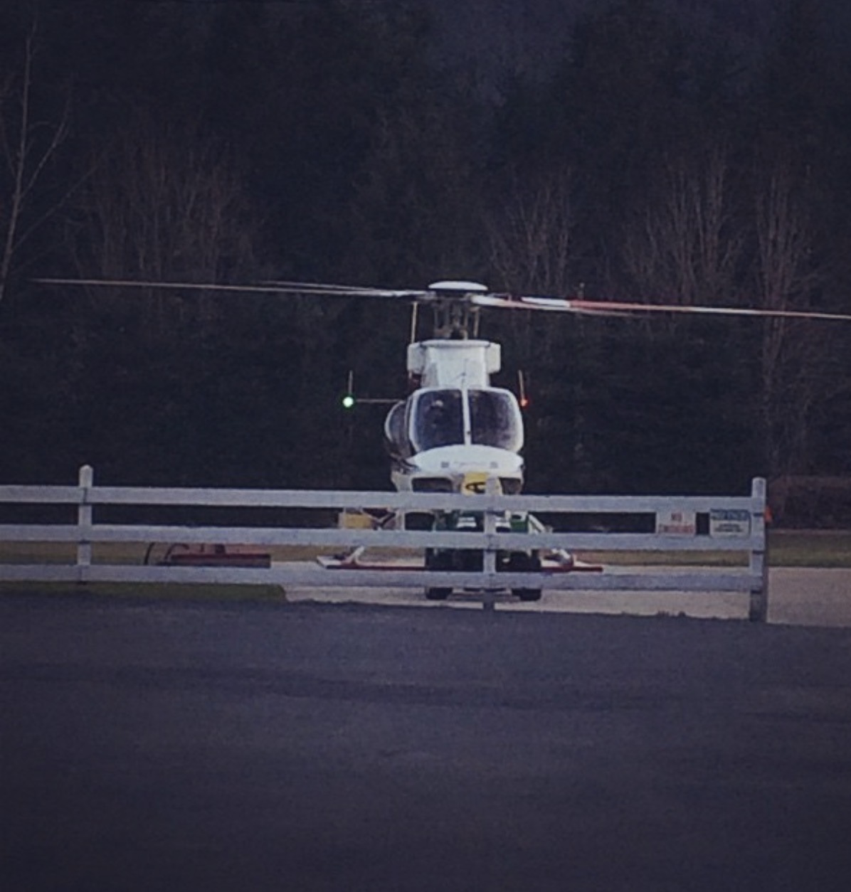 Helicopter with long-line sling delivering equipment to a remote Alberta telecom site